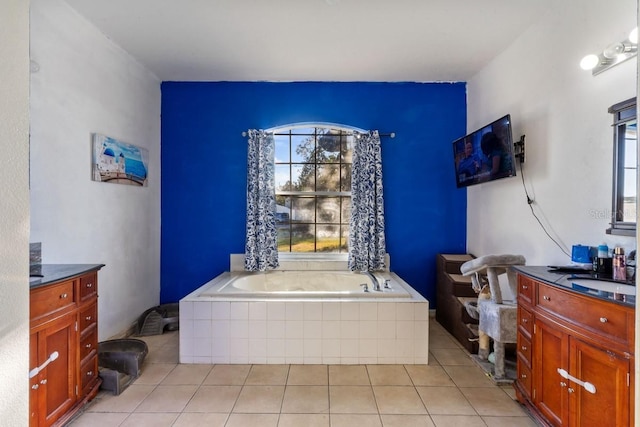 bathroom with tile patterned flooring, a wealth of natural light, and tiled bath