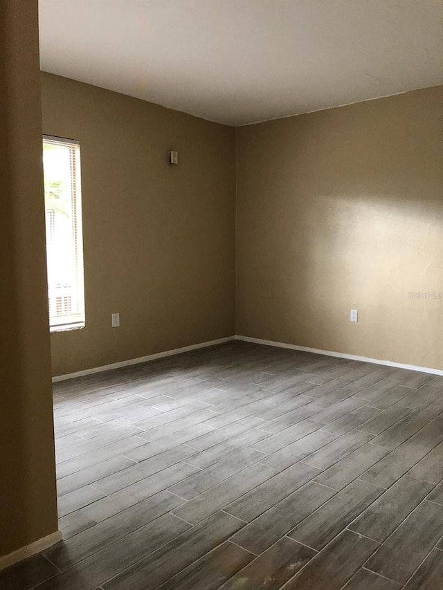 unfurnished room with dark hardwood / wood-style floors