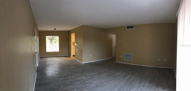 unfurnished room featuring dark wood-type flooring