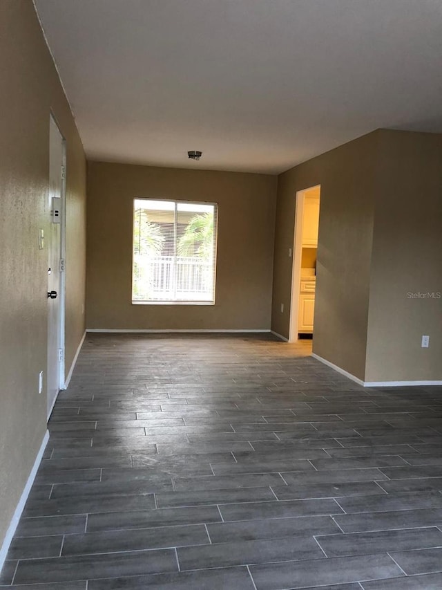 unfurnished room featuring dark wood-type flooring