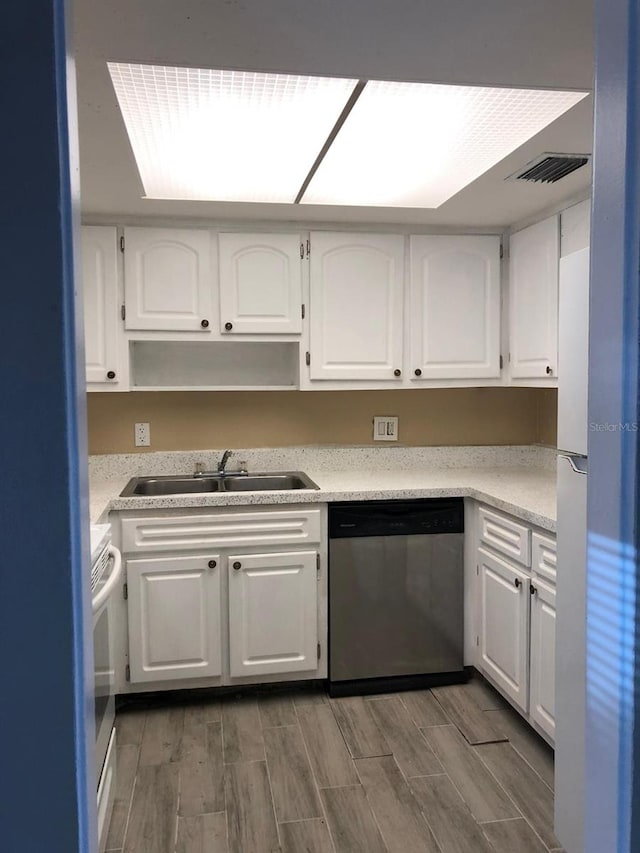 kitchen with sink, white cabinets, stainless steel dishwasher, and dark hardwood / wood-style floors