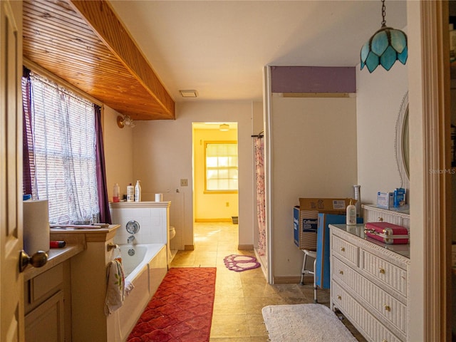 bathroom featuring vanity and a tub to relax in