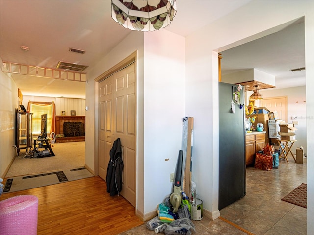 hallway with hardwood / wood-style floors