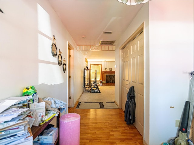 corridor with light hardwood / wood-style floors