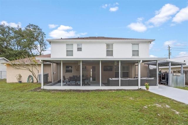 back of house featuring a sunroom, cooling unit, and a lawn