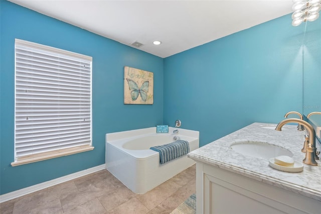 bathroom featuring tile patterned floors, a bathtub, and vanity