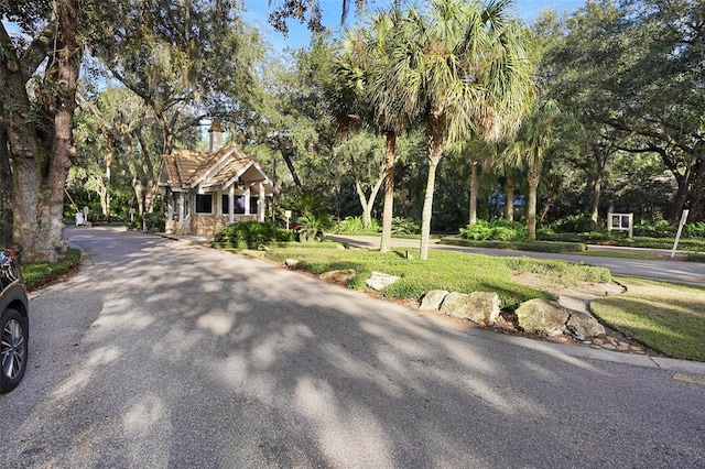 300 Spring Run Cir, Longwood, FL 32779 - view of front of home with a chimney, view of wooded area, and stone siding