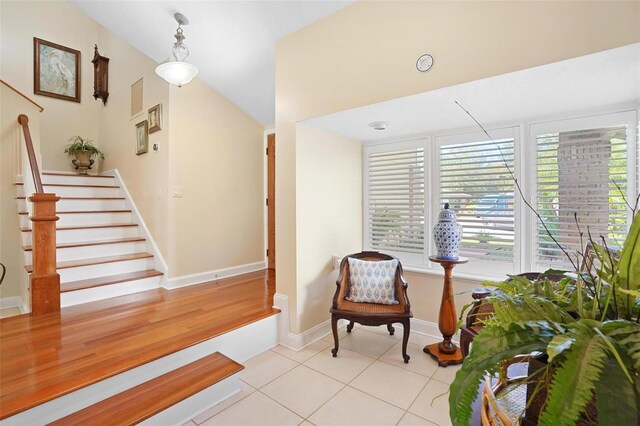 sitting room featuring light tile patterned floors and vaulted ceiling