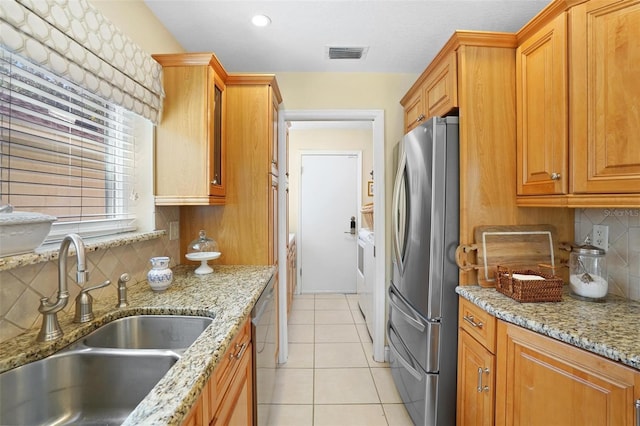 300 Spring Run Cir, Longwood, FL 32779 - kitchen with a sink, stainless steel appliances, washer and dryer, backsplash, and light tile patterned floors