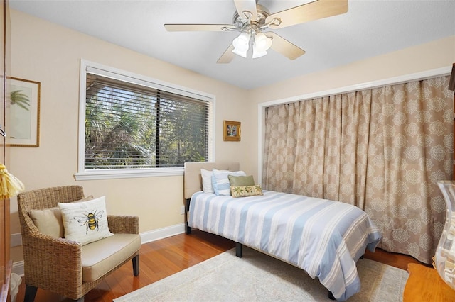 bedroom with hardwood / wood-style flooring and ceiling fan