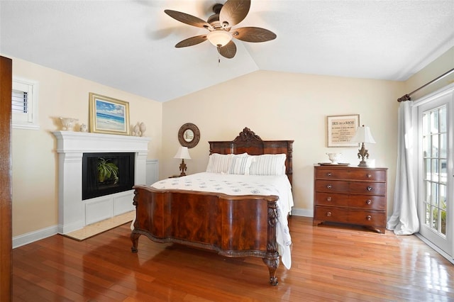 bedroom featuring ceiling fan, lofted ceiling, and light wood-type flooring