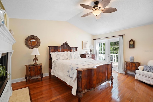 bedroom featuring ceiling fan, french doors, lofted ceiling, access to outside, and hardwood / wood-style flooring