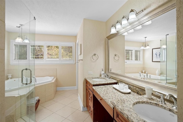 bathroom featuring tile patterned floors, separate shower and tub, vanity, and a notable chandelier