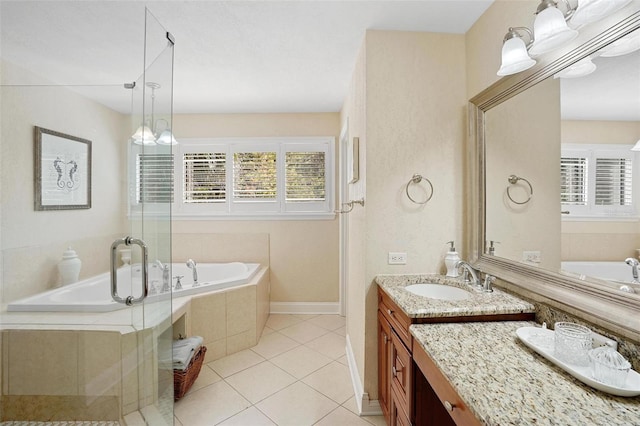 bathroom featuring tile patterned floors, vanity, and a relaxing tiled tub