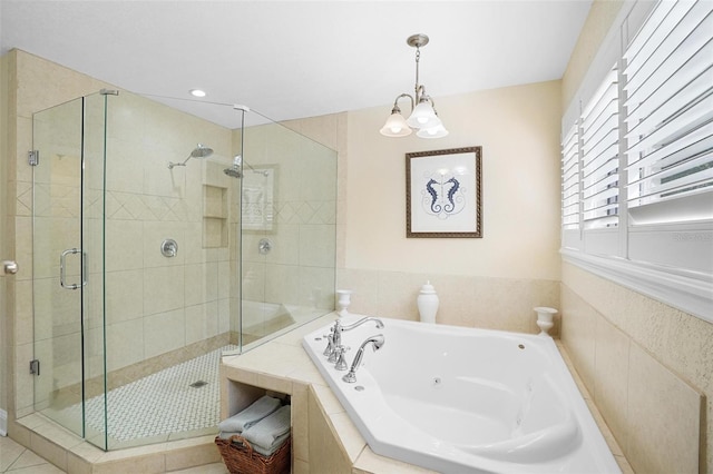 bathroom featuring tile patterned flooring, a notable chandelier, and shower with separate bathtub