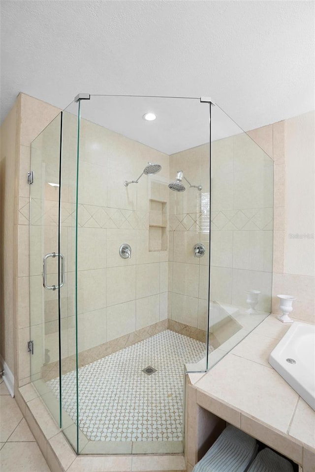 bathroom with tile patterned flooring, a textured ceiling, and plus walk in shower