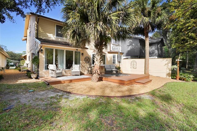 rear view of property with a lawn, an outdoor hangout area, and a deck