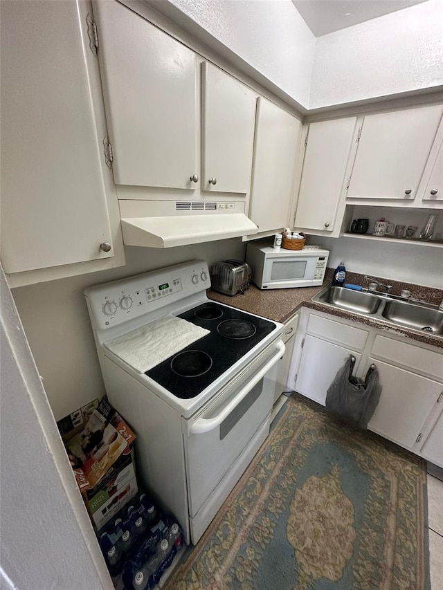 kitchen with white cabinetry, white appliances, and range hood