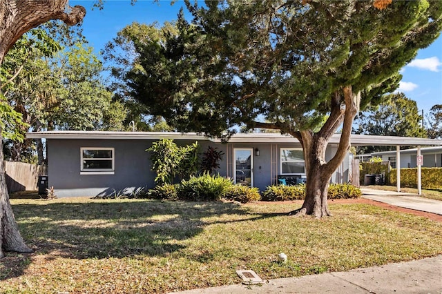 view of front of property featuring a carport and a front lawn