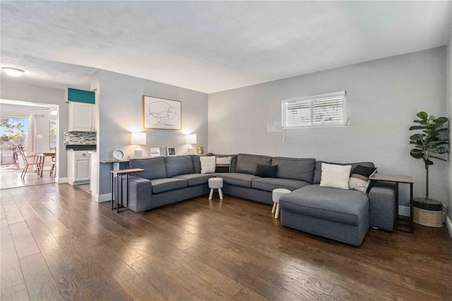 living room featuring ceiling fan and dark hardwood / wood-style flooring