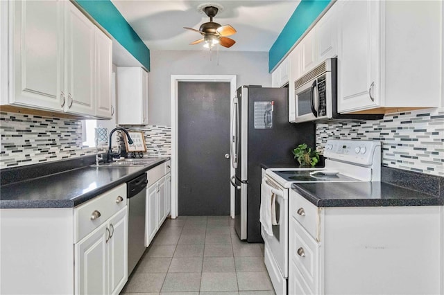 kitchen with backsplash, sink, light tile patterned floors, white cabinetry, and stainless steel appliances