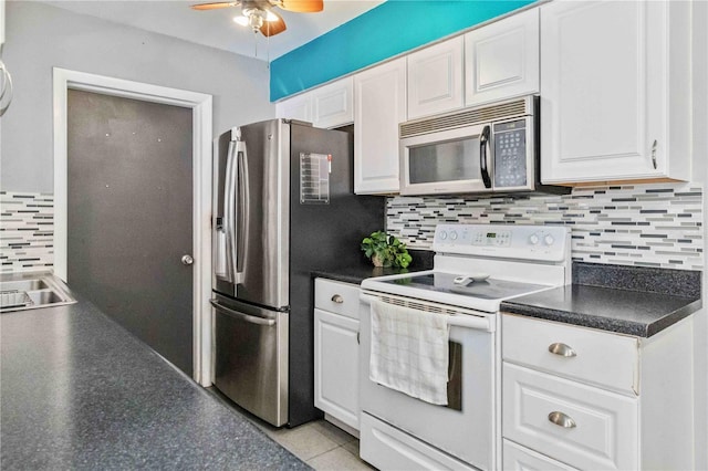 kitchen featuring white cabinets, stainless steel appliances, tasteful backsplash, and sink