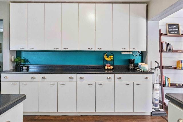 kitchen featuring white cabinets and dark wood-type flooring