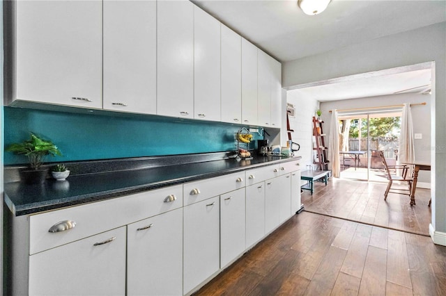 kitchen featuring white cabinets and dark wood-type flooring