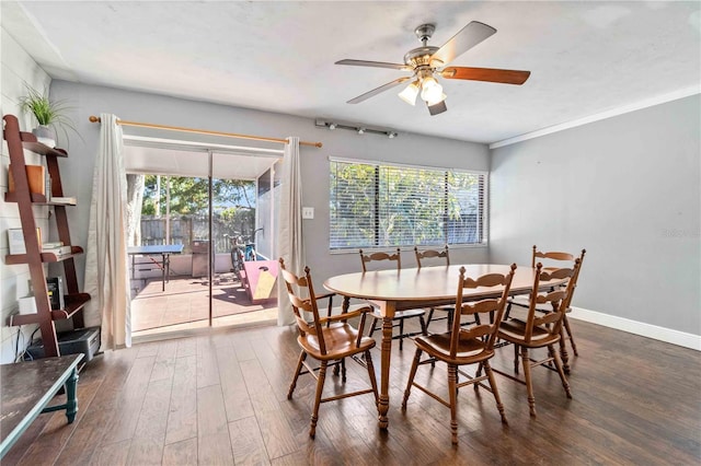 dining space with crown molding, ceiling fan, and dark wood-type flooring