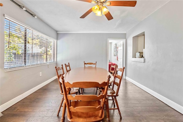 dining area with dark hardwood / wood-style floors, ceiling fan, and crown molding