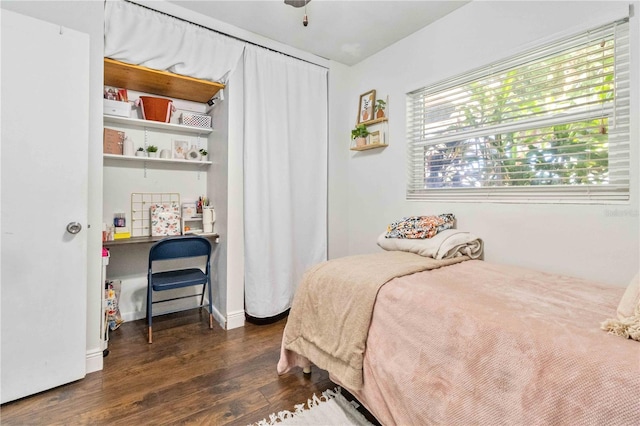 bedroom featuring ceiling fan and dark wood-type flooring