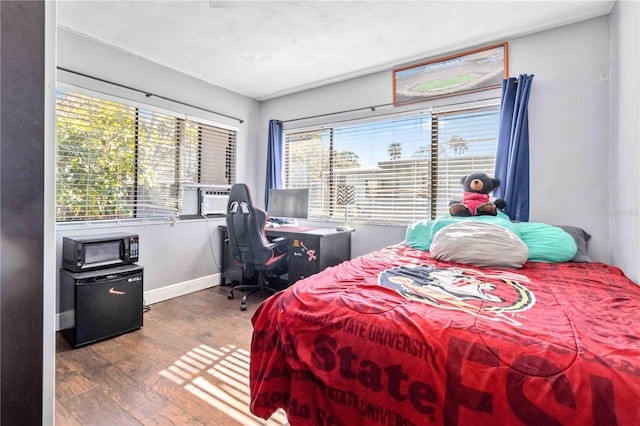 bedroom with hardwood / wood-style floors and cooling unit