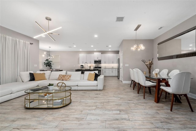 living room with sink and an inviting chandelier