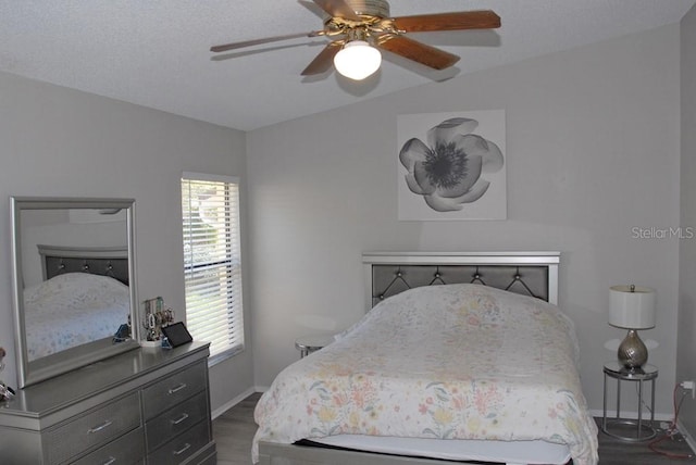 bedroom with ceiling fan and dark wood-type flooring