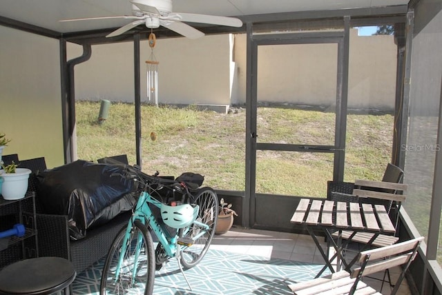 sunroom / solarium featuring ceiling fan