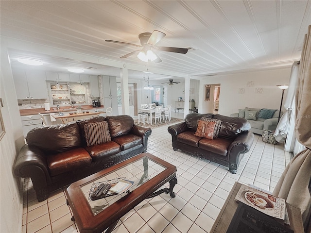 living room featuring ceiling fan and light tile patterned floors