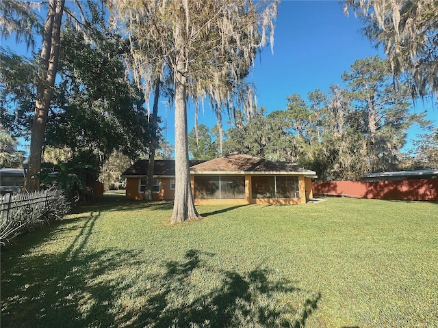 view of yard with a sunroom