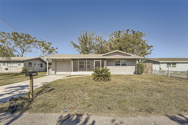 single story home featuring a carport, a sunroom, and a front lawn