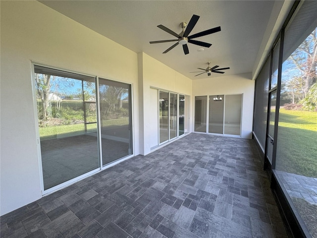 unfurnished sunroom featuring ceiling fan and lofted ceiling