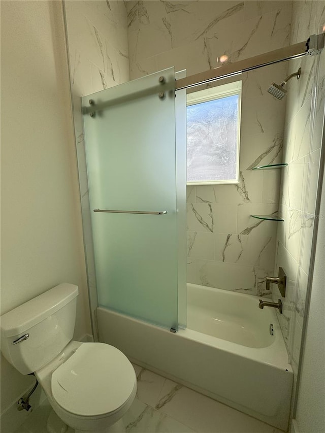 bathroom featuring toilet and tiled shower / bath