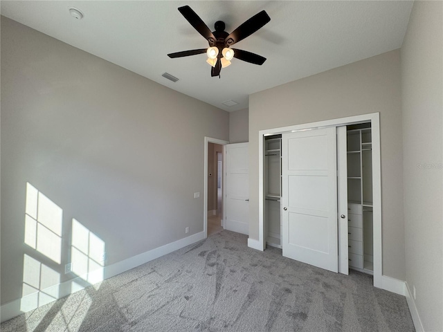 unfurnished bedroom with ceiling fan, a closet, and light colored carpet