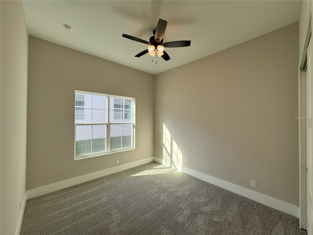 carpeted empty room with ceiling fan