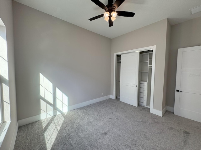 unfurnished bedroom featuring light carpet, a closet, and ceiling fan