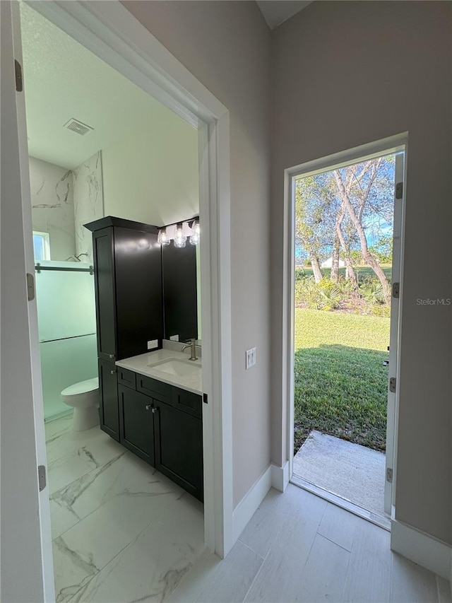 bathroom featuring vanity and toilet