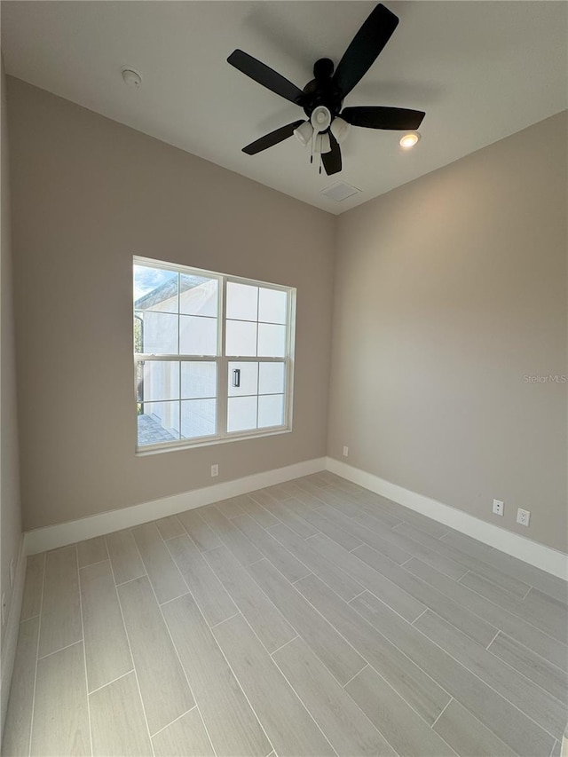 spare room with ceiling fan and light hardwood / wood-style flooring