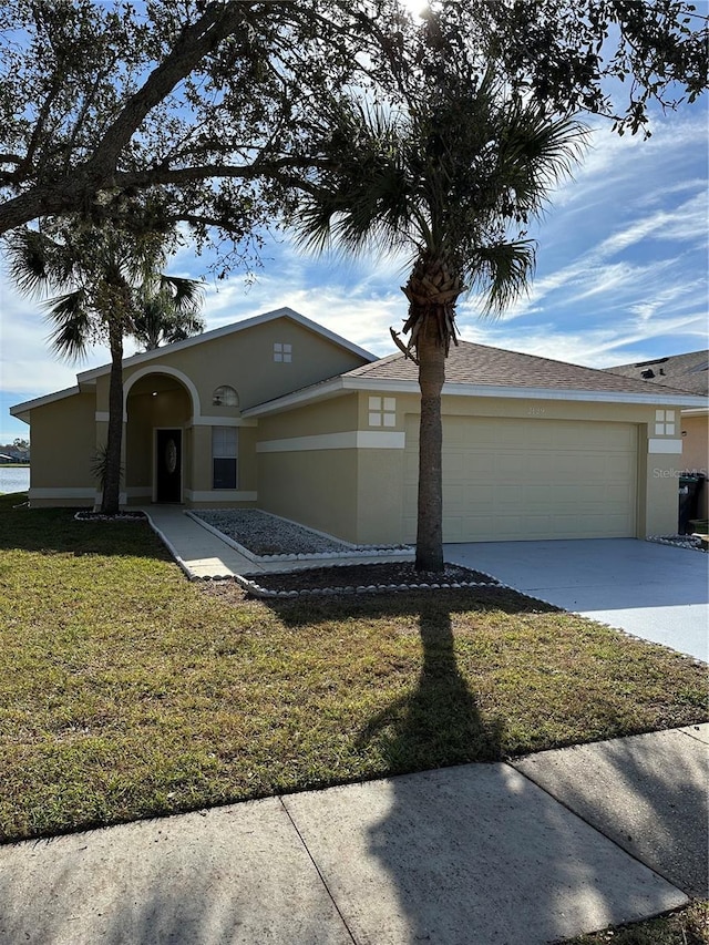 view of front facade with a garage and a front lawn