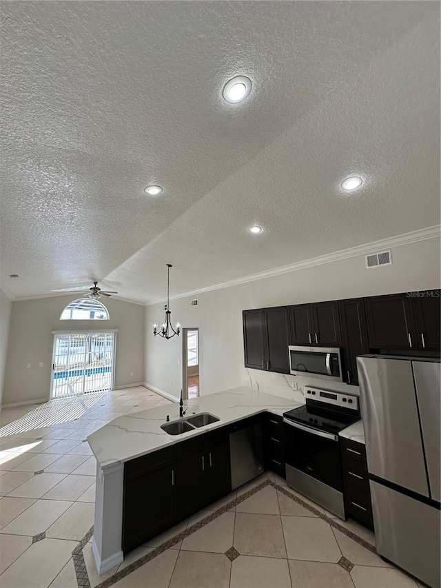 kitchen featuring kitchen peninsula, sink, a textured ceiling, and appliances with stainless steel finishes