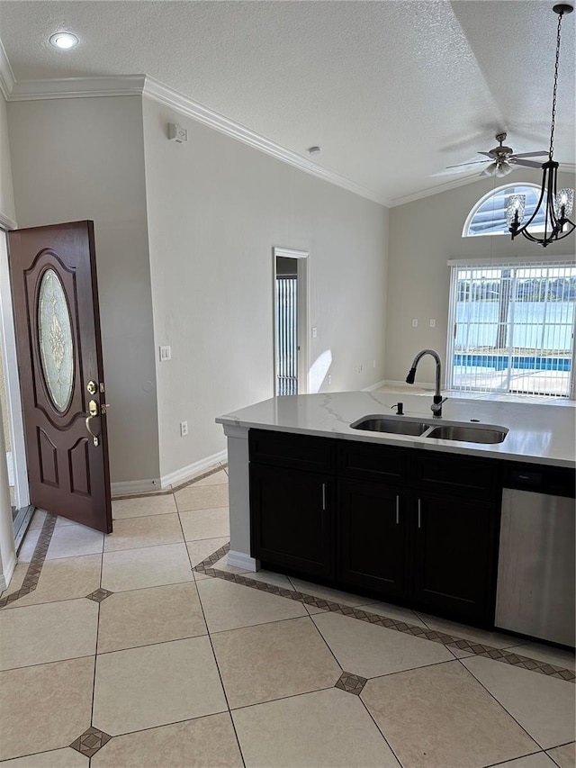 kitchen with dishwasher, sink, hanging light fixtures, a textured ceiling, and light tile patterned flooring