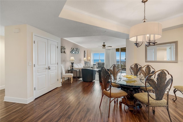 dining room featuring dark hardwood / wood-style flooring, ceiling fan with notable chandelier, and ornamental molding