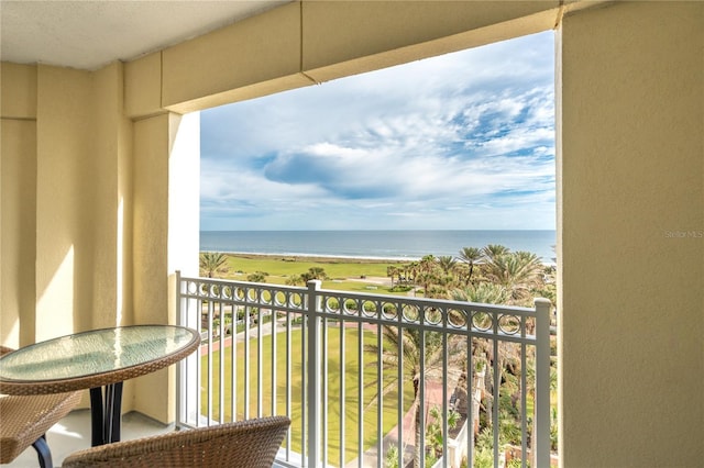 balcony featuring a water view and a view of the beach